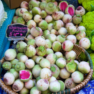 a basket filled with watermelon radishes