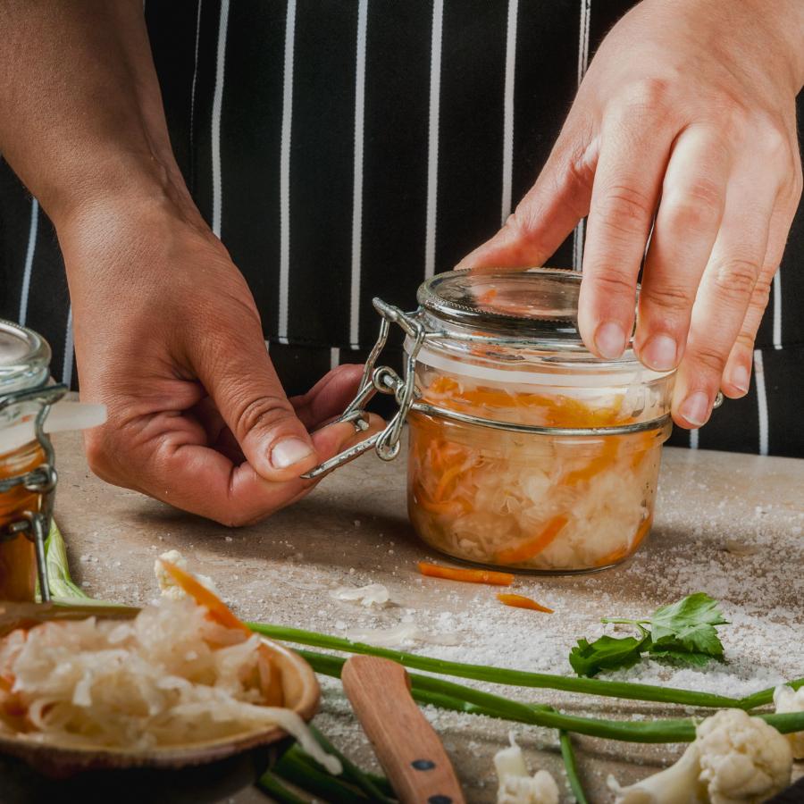 photo of hands and a jar of preserved food